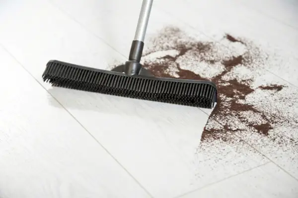 FURemover Compact rubber broom gathering debris on a hard floor